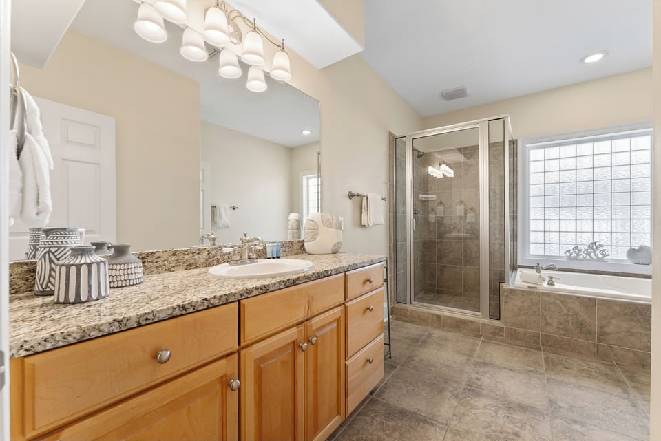Your master bathroom has a beautiful vanity with a huge mirror, a separate shower & soaker tub, and a separate water closet.