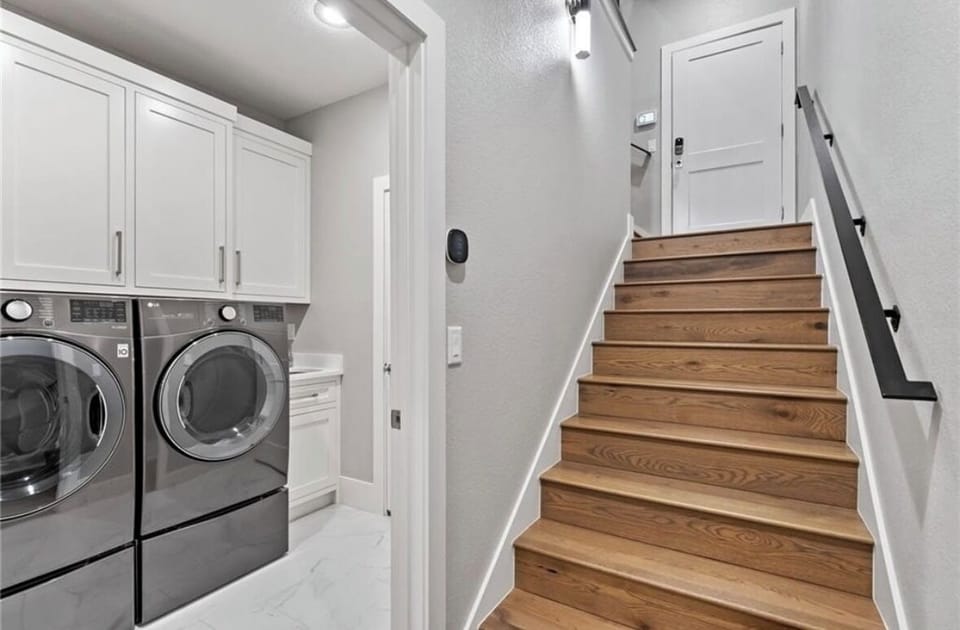 Lower level entry with laundry featuring high end LG appliances