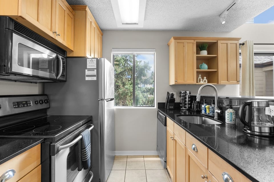 Full stocked kitchen with a drip coffee pot, keurig and electric tea kettle.
