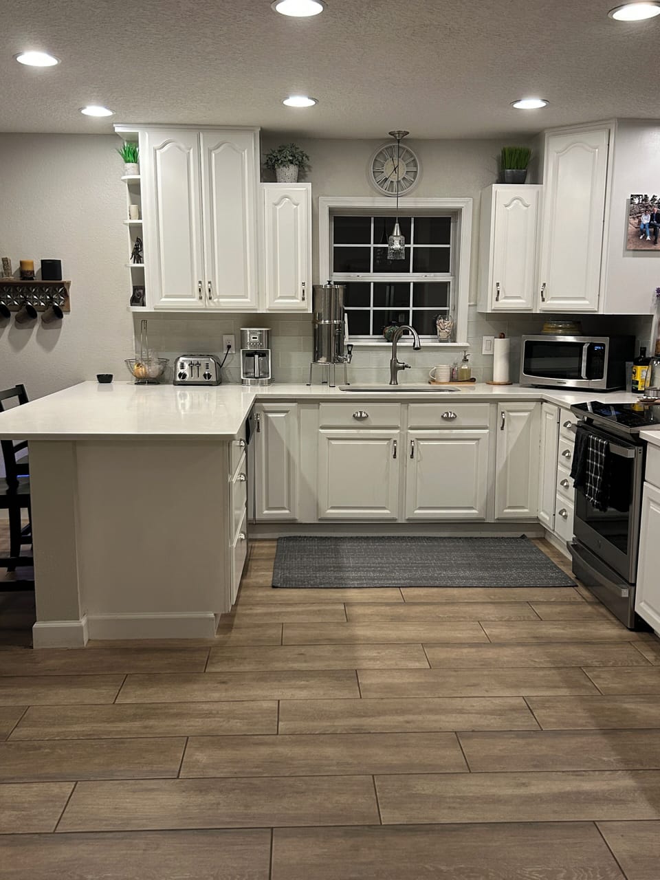 Large, functional kitchen with induction range and bar seating on both sides!