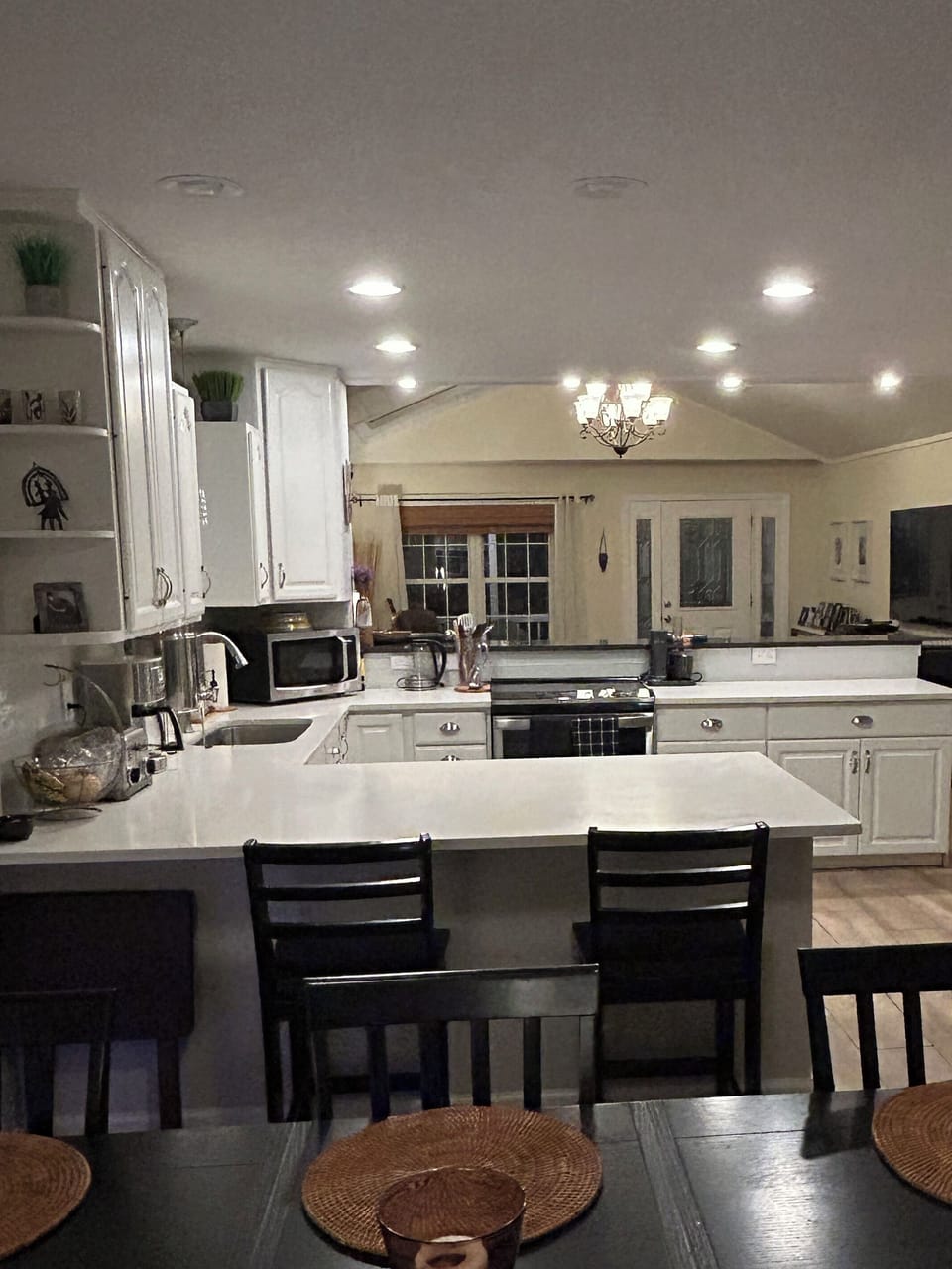 Large, functional kitchen with induction range and bar seating on both sides!