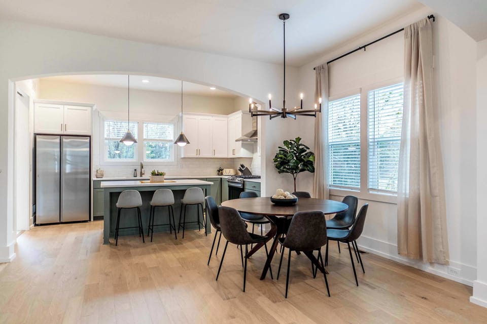 There are several options for family and friends to enjoy a meal together including seating at the kitchen island as well as around the dining table.