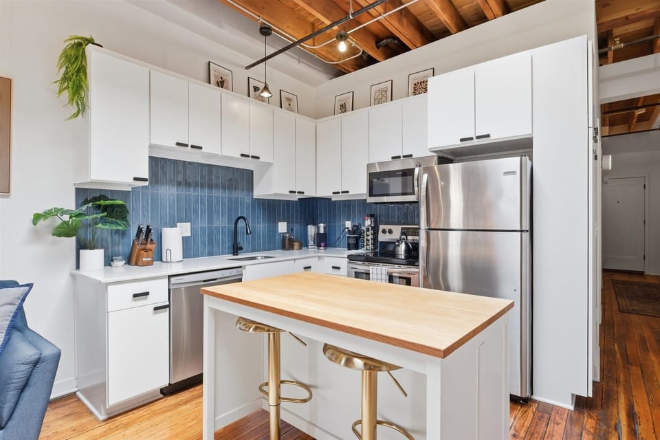 High ceilings and a modern kitchen attached to the living area