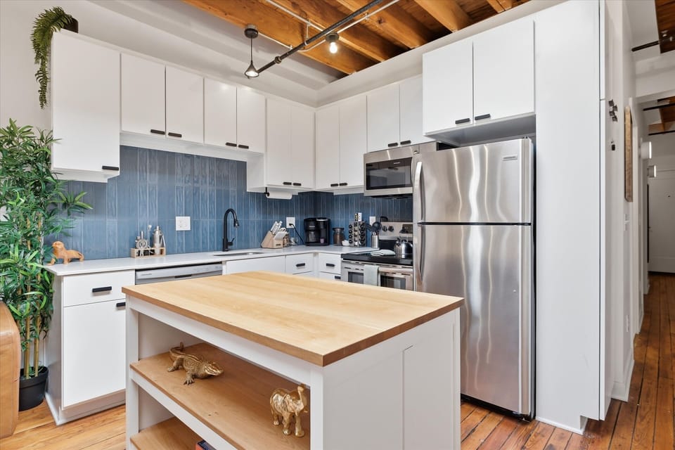 Fully stocked kitchen with an island and barstools for dining
