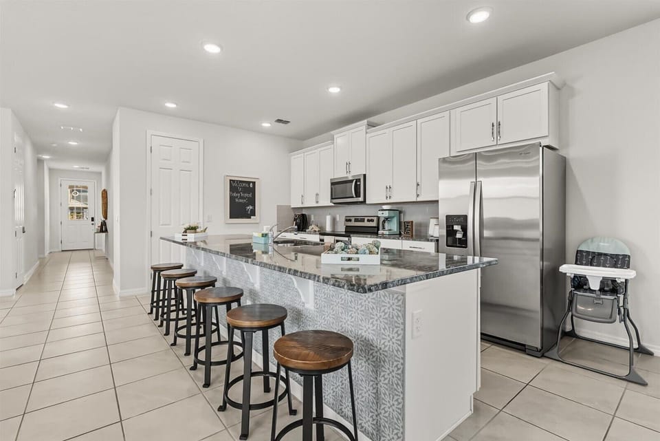 From the breakfast bar, you can overlook the fully equipped modern kitchen.
