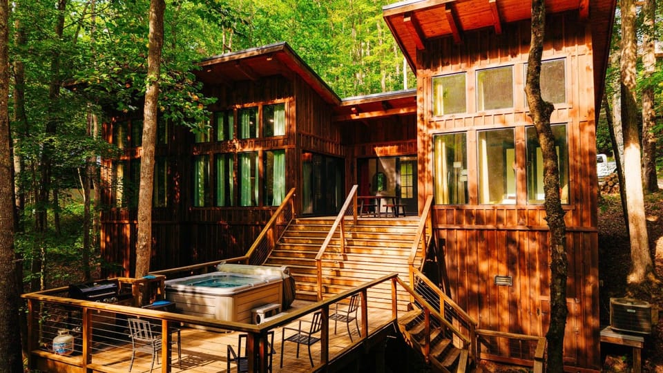The main stair and hot tub deck, wrapped in peak fall color — this is the view that sells the whole stay.