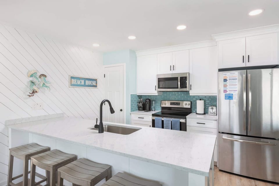 Well-equipped kitchen with bright, modern design and open upper-level layout (w/ spacious counter, fridge, stove, oven, microwave, toaster, Keurig & drip, and more)