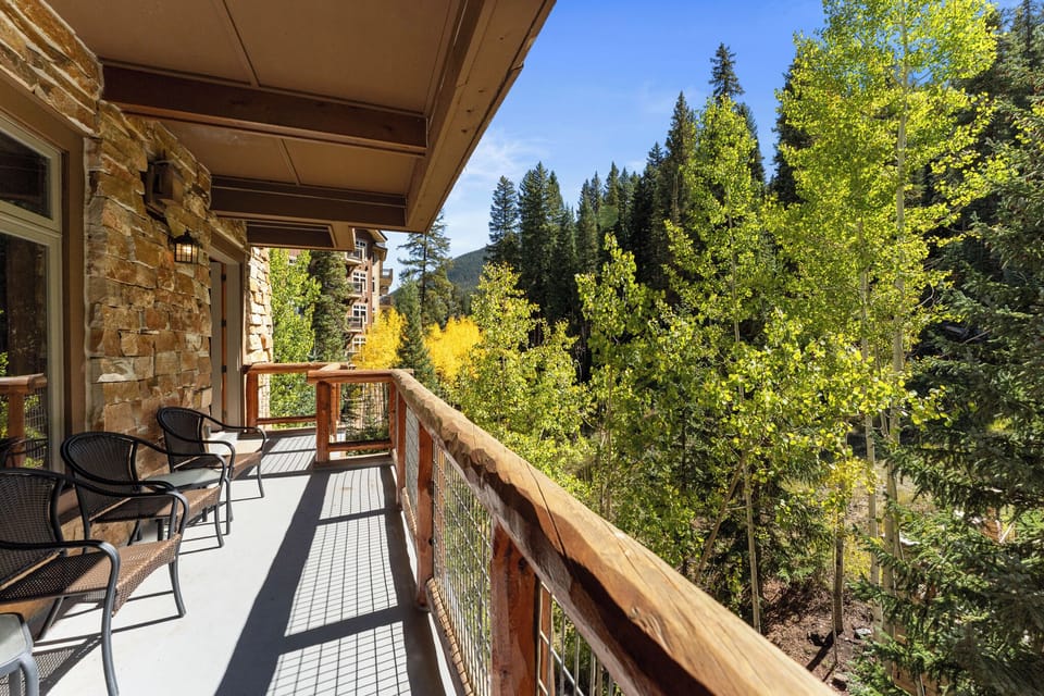 Relax on your private balcony overlooking autumn's golden aspen trees and towering mountain peaks.