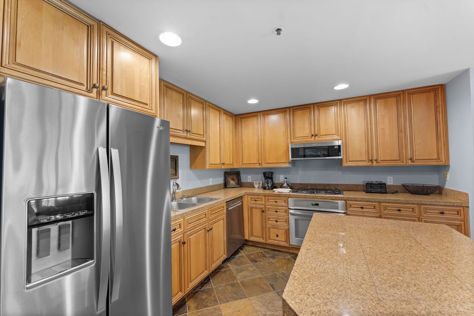 Step into your fully-equipped kitchen with granite counters, stainless appliances, and ample cabinet space for effortless meal prep.