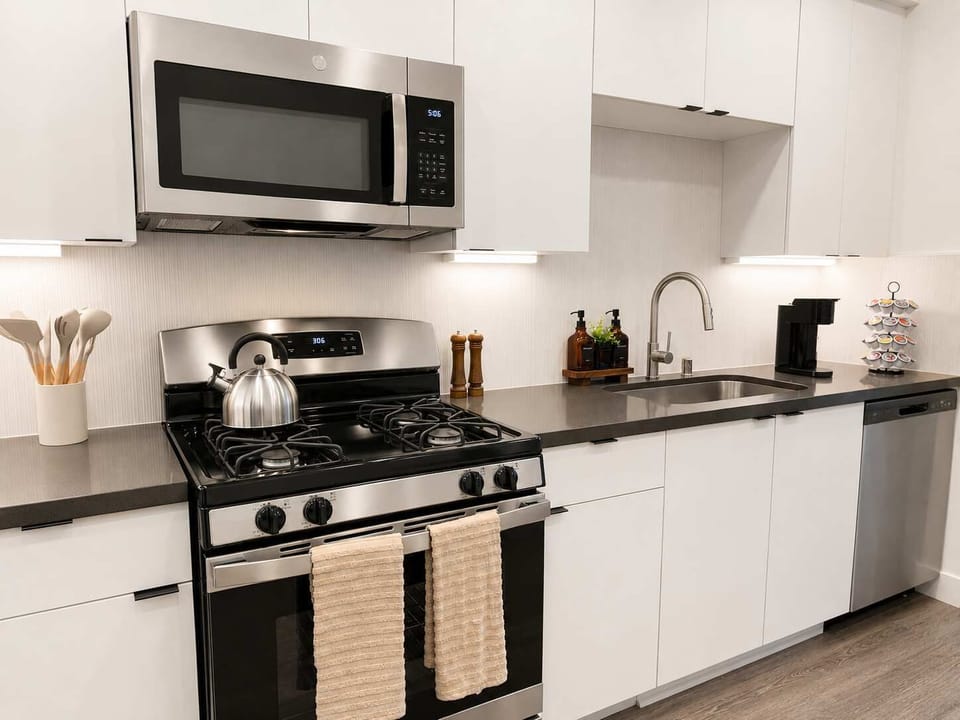 Experience extended comfort with a fully equipped kitchen featuring a coffee machine, stovetop, and microwave—everything you need for a seamless long-term stay.