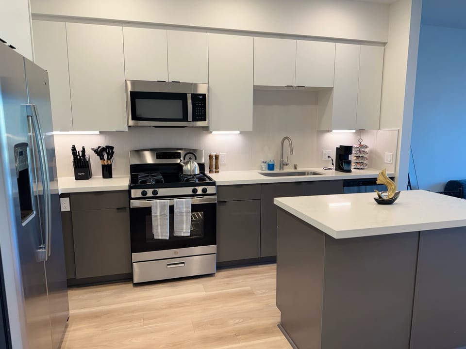 Experience extended comfort with a fully equipped kitchen featuring a coffee machine, stovetop, and microwave—everything you need for a seamless long-term stay.