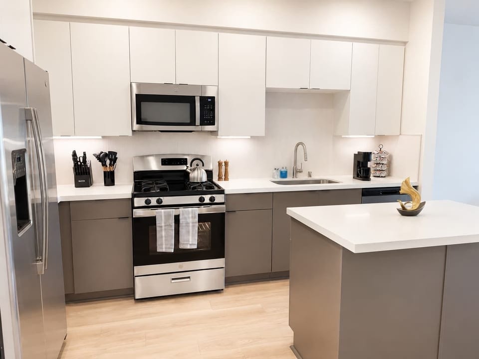 Experience extended comfort with a fully equipped kitchen featuring a coffee machine, stovetop, and microwave—everything you need for a seamless long-term stay.