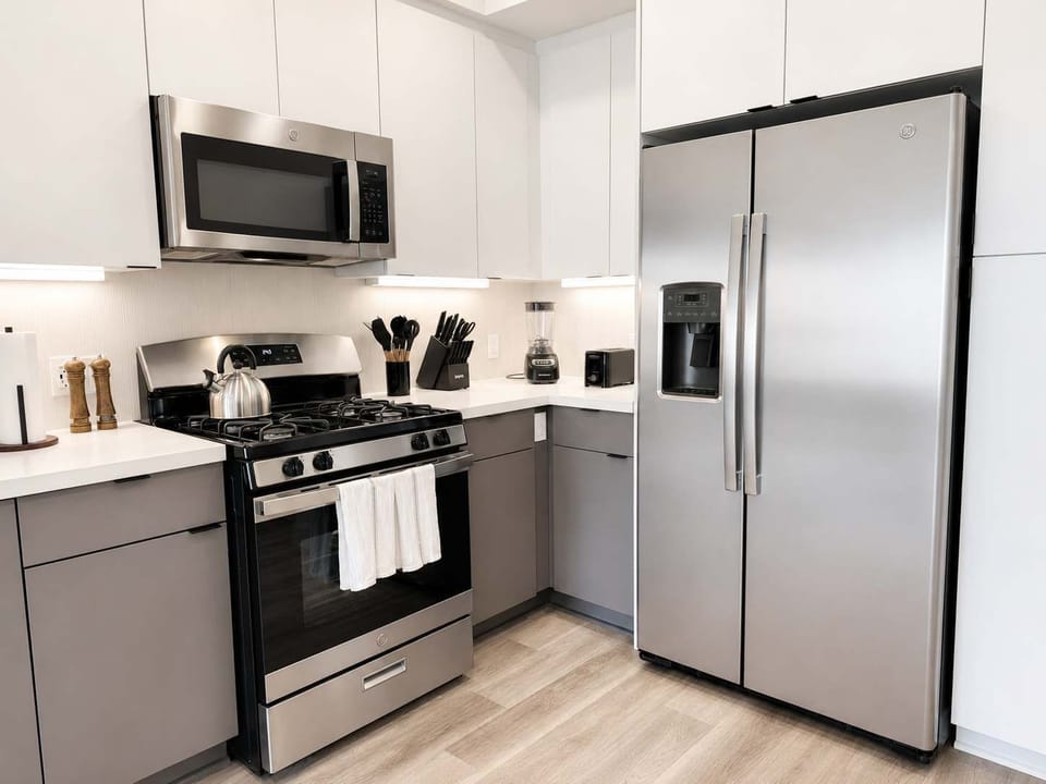 Experience extended comfort with a fully equipped kitchen featuring a coffee machine, stovetop, and microwave—everything you need for a seamless long-term stay.