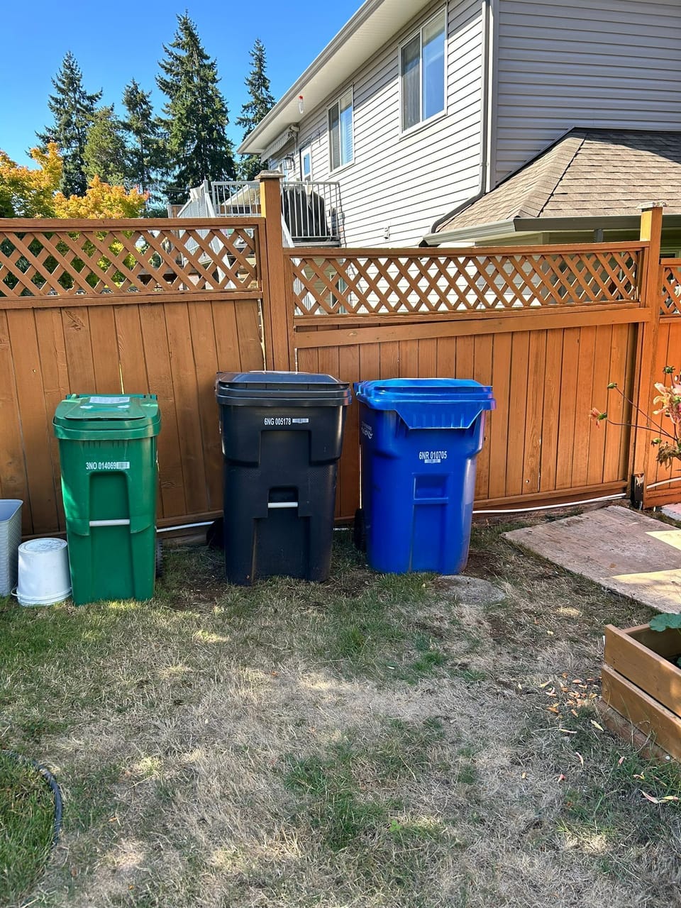 Garbage bins, Green for compost, blue for plastics and cans, grey for glasses, and black for all others.