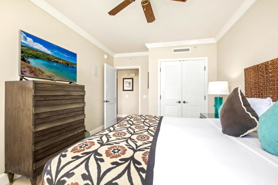 Bright coastal bedroom with TV, tropical accents, and stylish decor. HKK-449