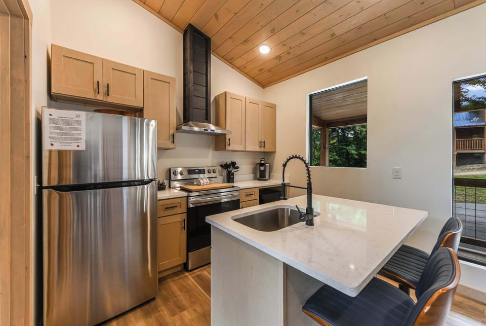 Modern kitchen with stainless steel appliances and a marble island for casual dining.