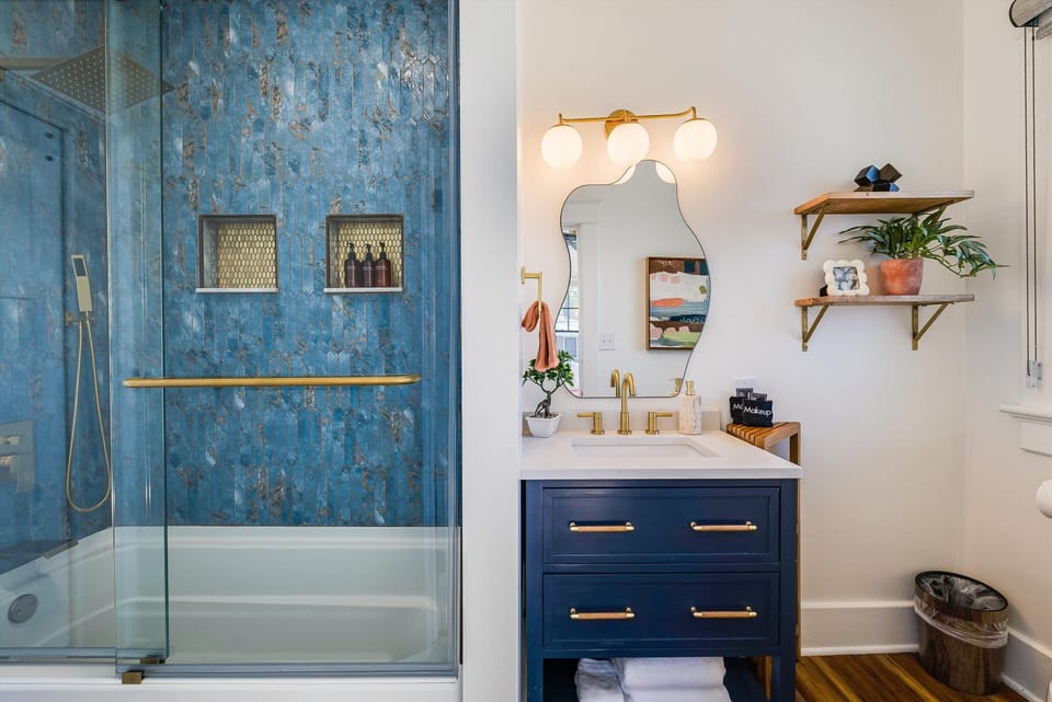Bathroom with tub/shower combo. Toiletries provided (shampoo, conditioner, body wash, and hand soap)