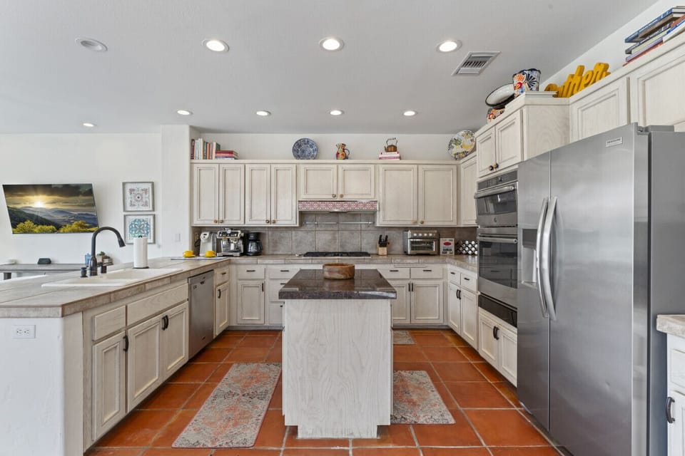 Spacious kitchen w/ large island, ample cabinetry & stainless appliances