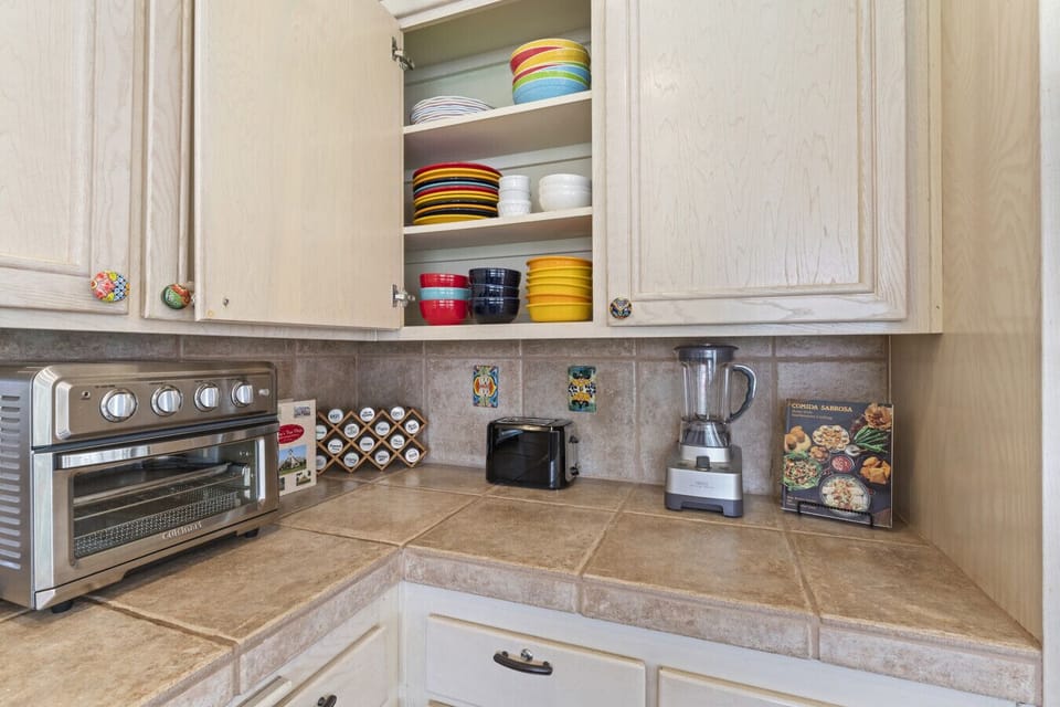 Coffee station w/ countertop appliances & neatly arranged essentials