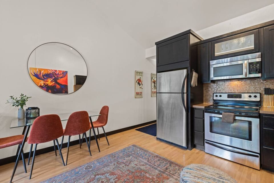 Enjoy meals together at the cozy dining table with seating for four — great for family breakfasts, casual dinners, or game nights after a day exploring Park City.