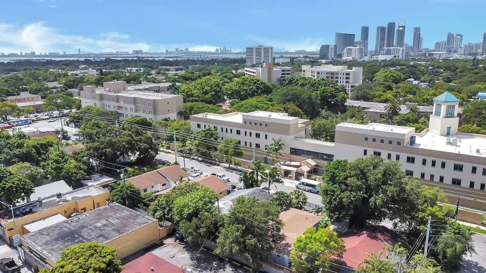 Stunning cityscape view showcasing lush greenery and downtown Miami’s skyline in the distance.