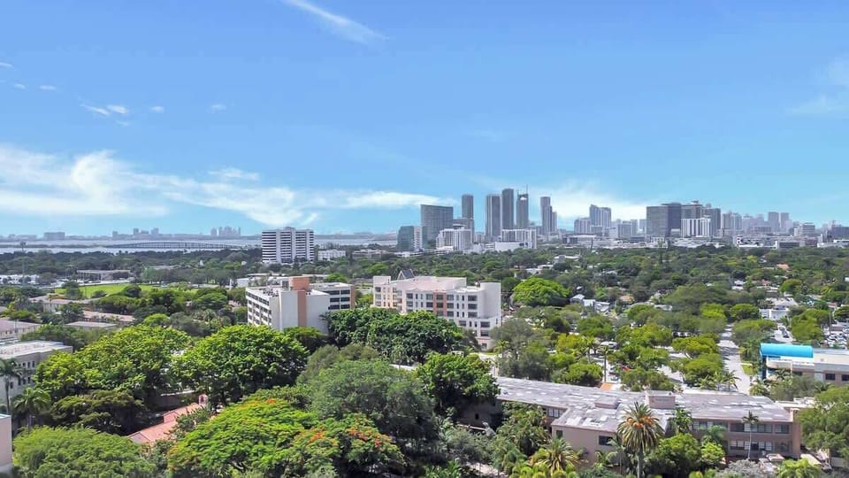 Stunning cityscape view showcasing lush greenery and downtown Miami’s skyline in the distance.
