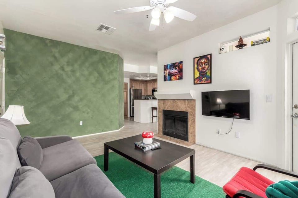 Bright living space with cozy seating and Smart TV.