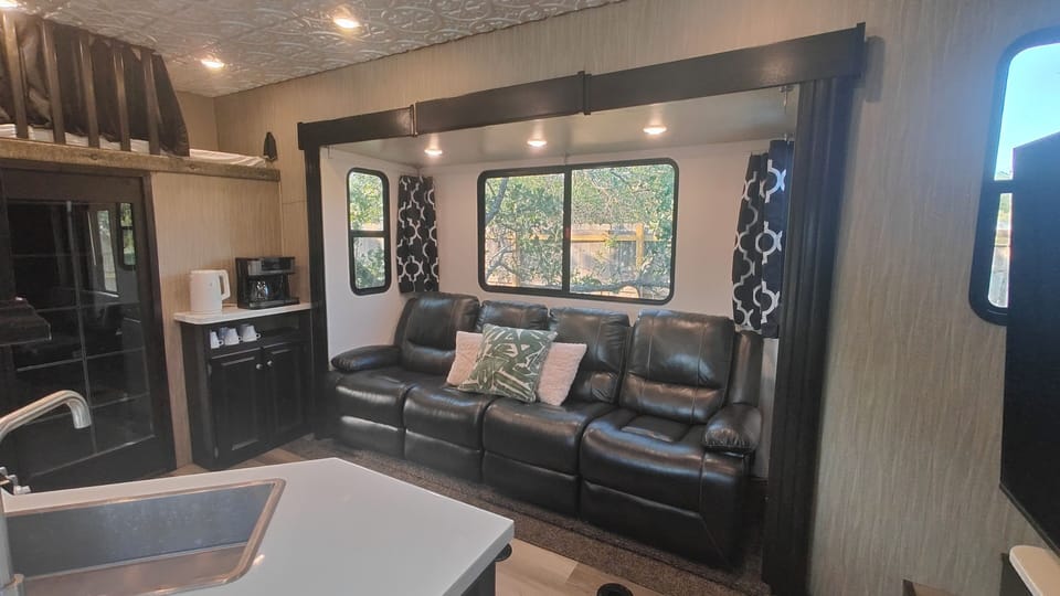 4 recliners with a coffee bar on the left.