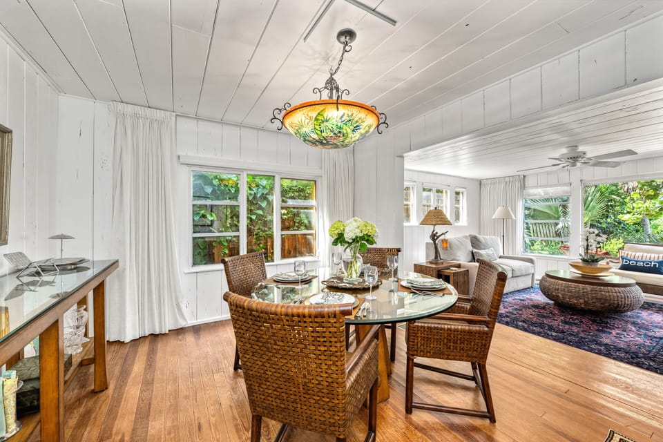 Gather for meals surrounded by glowing white washed wood and tropical light.