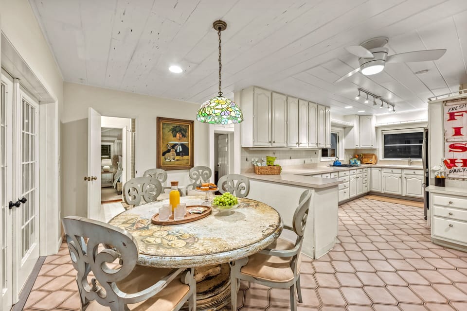 Step inside and you're home — the scent of salt still in the air, and a bright coastal kitchen opening wide with space to gather, cook, and linger late into the evening.
