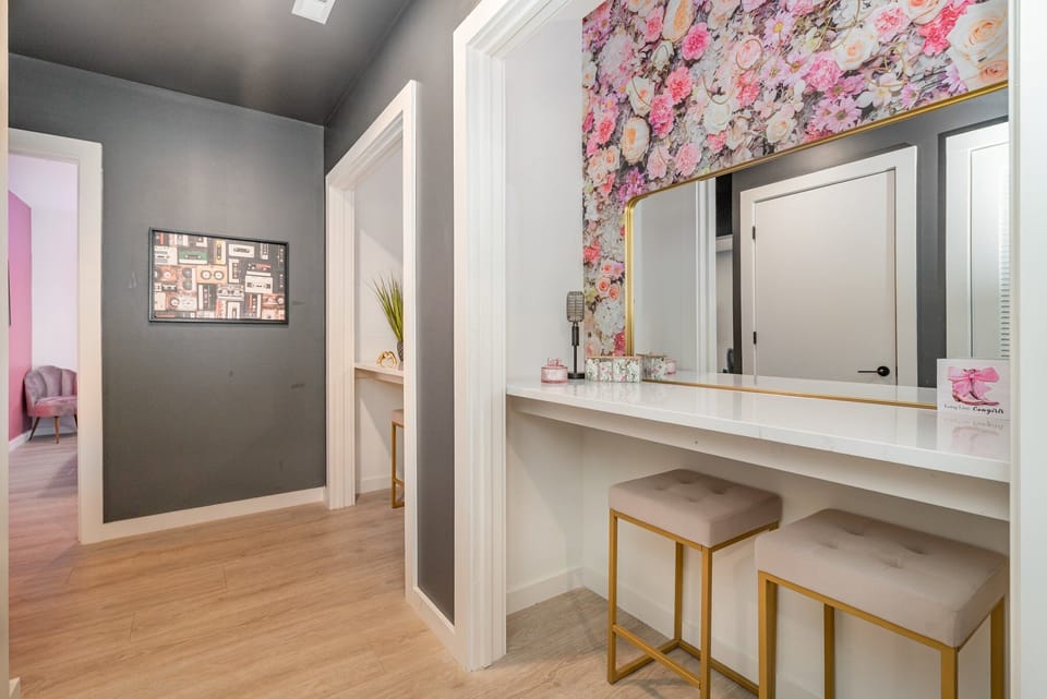 Dual get-ready stations with floral accents, large mirrors, and plenty of counter space—perfect for prepping in style.