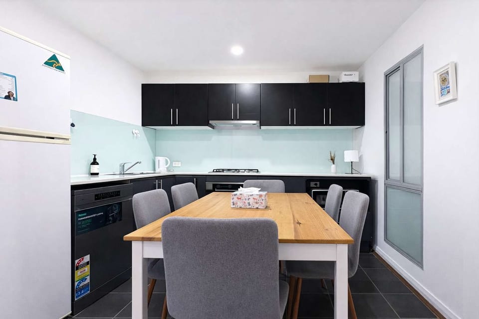 Full View of Modern Kitchen and Six-Seater Dining Table