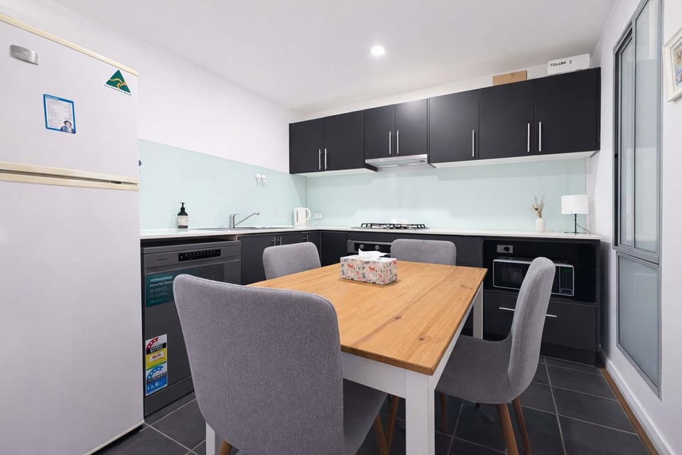 Contemporary Kitchen with Black Cabinetry and Dining Set
