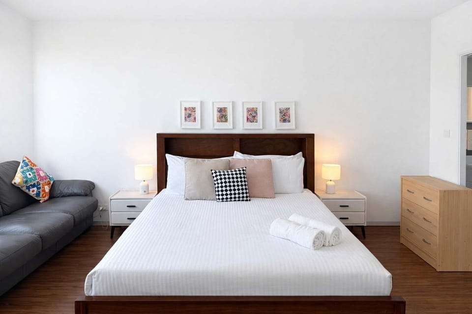 Bright Bedroom Featuring Wooden Bed Frame and Nightstands