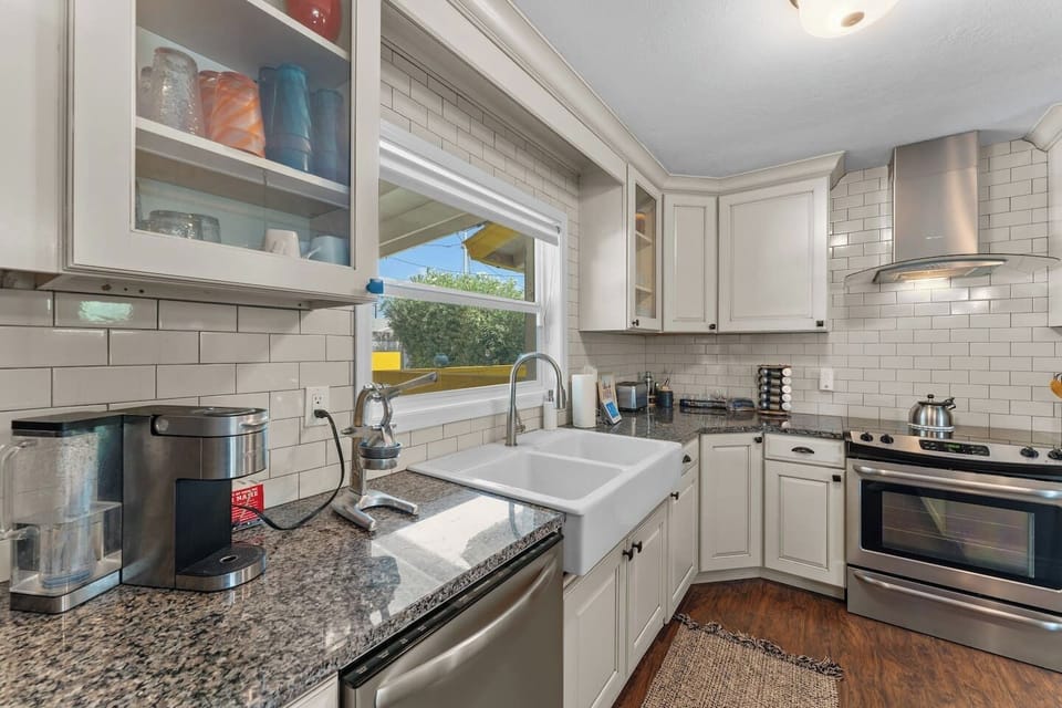 Farmhouse sink, Keurig coffee maker, and stainless range — everything you need to cook in.