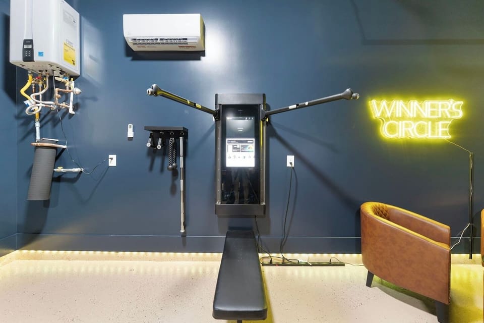 Stay fit with the Tonal smart gym setup — a sleek, high-tech workout station right in the game room.