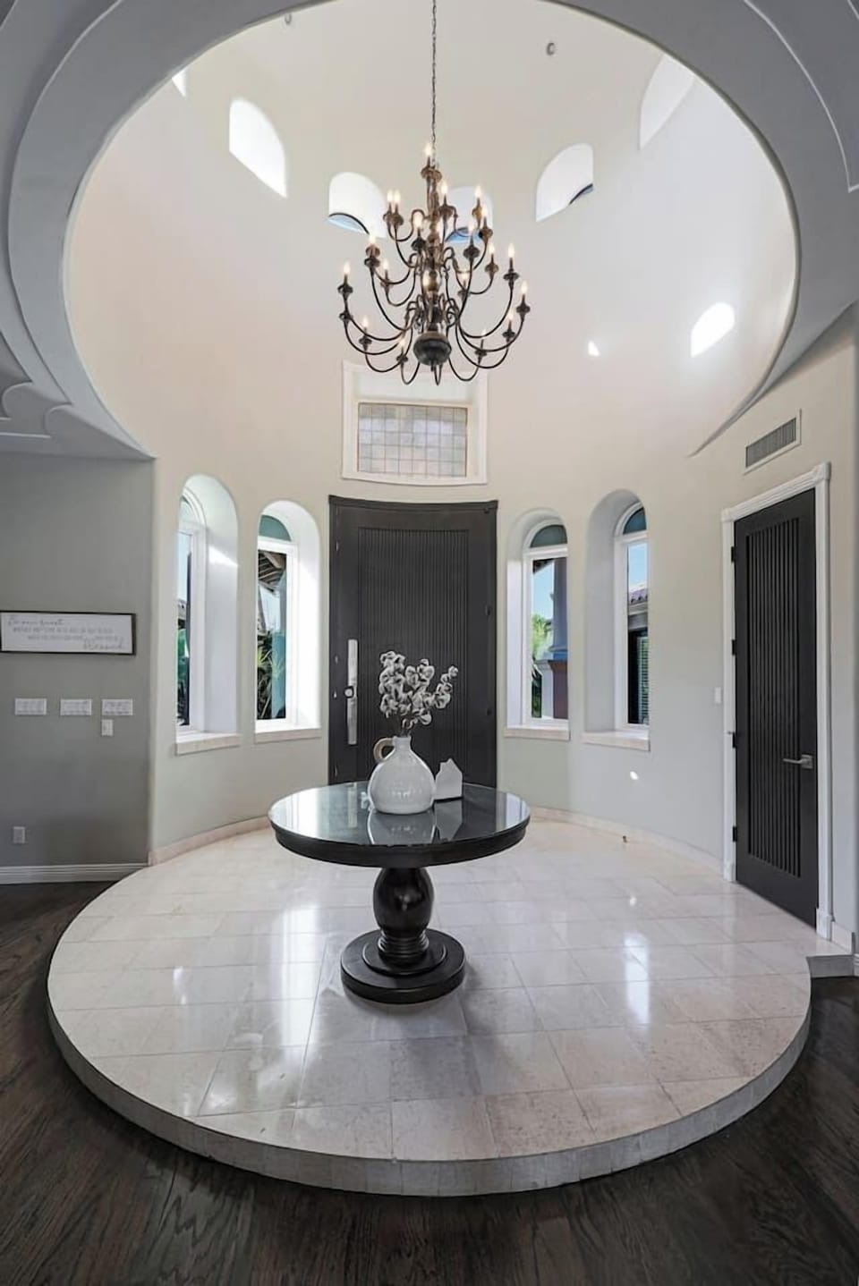 Marvel at the dramatic circular foyer crowned by a classic chandelier—a stunning architectural introduction to your luxury getaway.