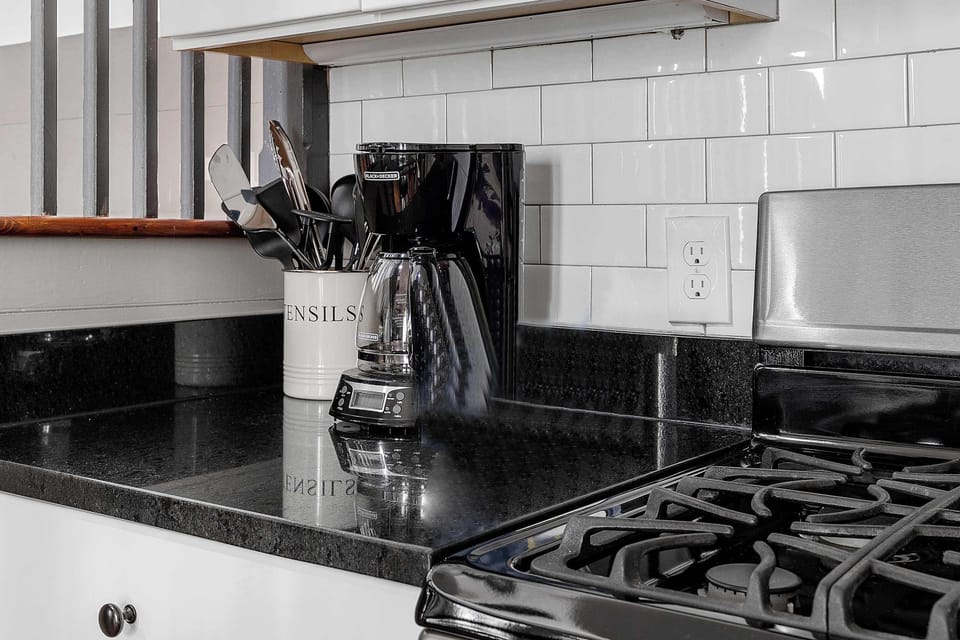 Fully equipped kitchen with modern appliances and a cozy dining area with seating for 4.