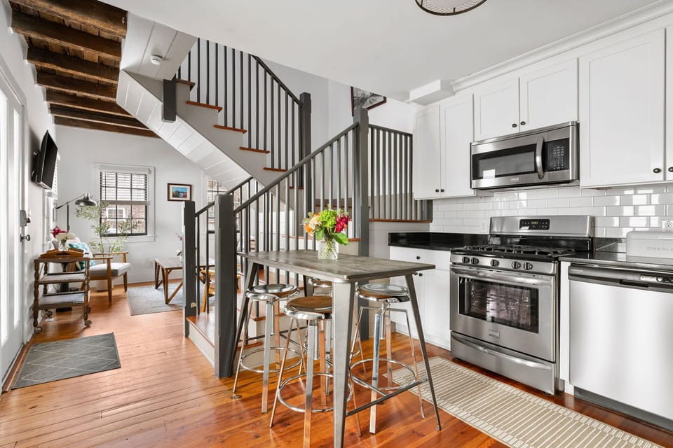 Fully equipped kitchen with modern appliances and a cozy dining area with seating for 4.