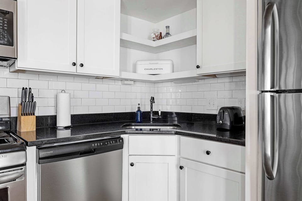 Fully equipped kitchen with modern appliances and a cozy dining area with seating for 4.