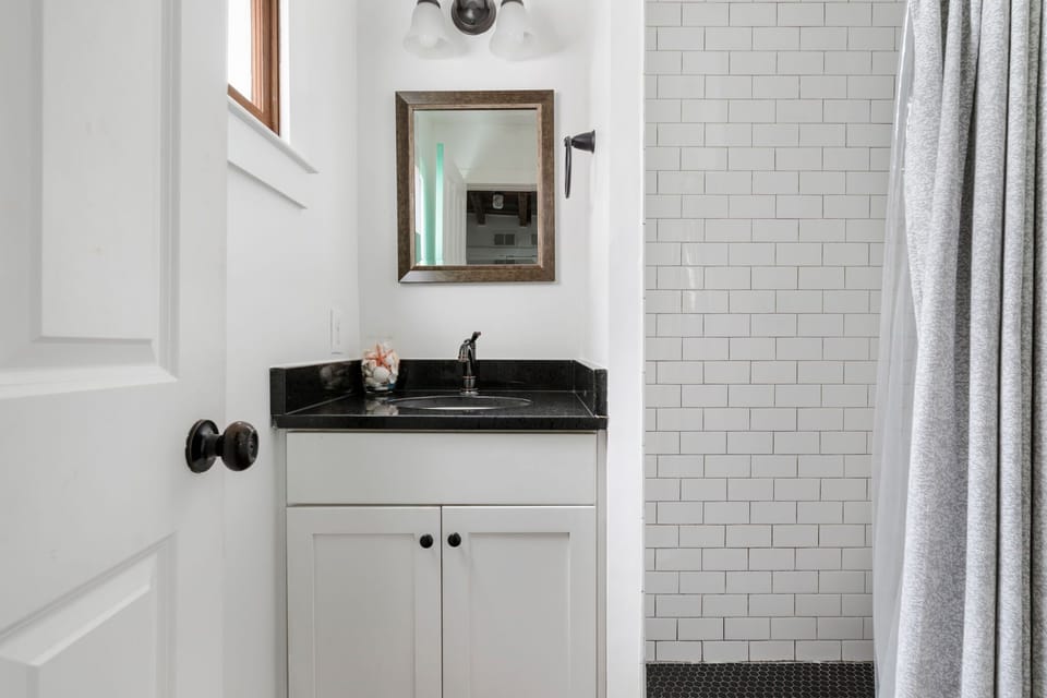 Bathroom 1: Bright and functional bathroom featuring a walk-in shower.
