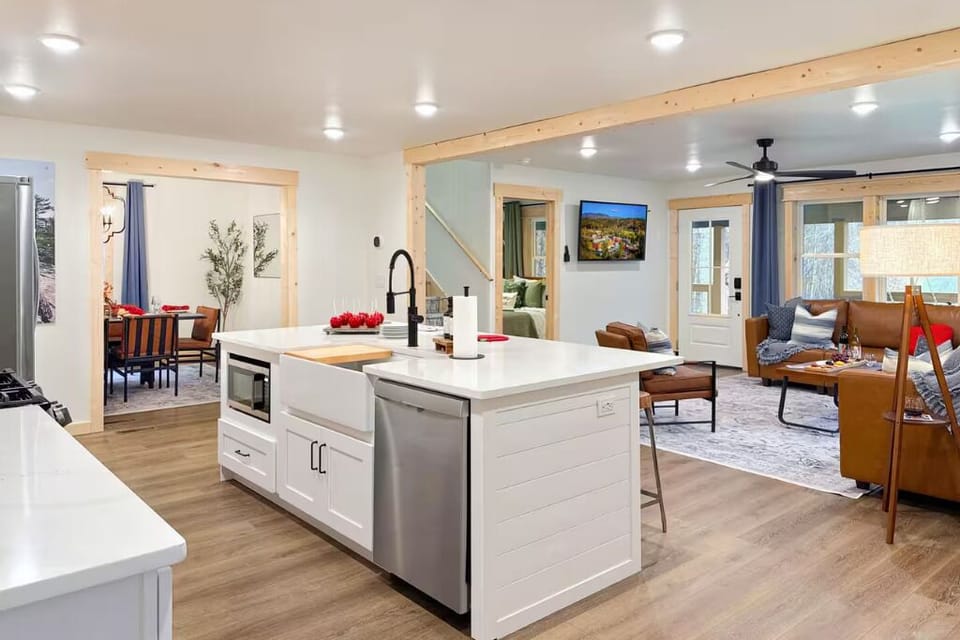 There's a large kitchen island with a sink and faucet.