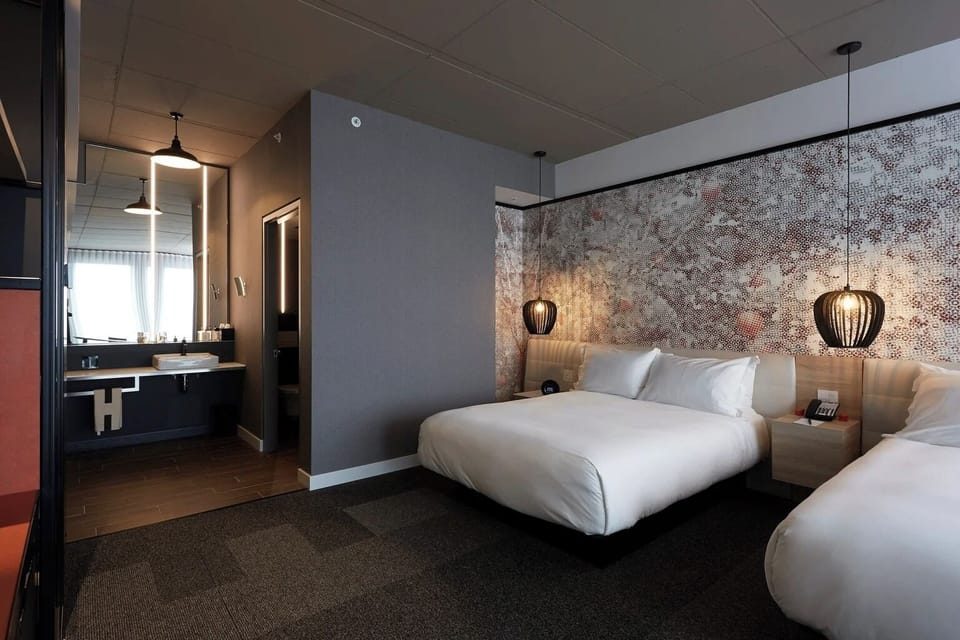 Settle into plush beds with a stylish, modern suite layout.