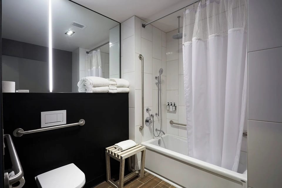 Indulge in a spotless bath with deep tub and rain shower.