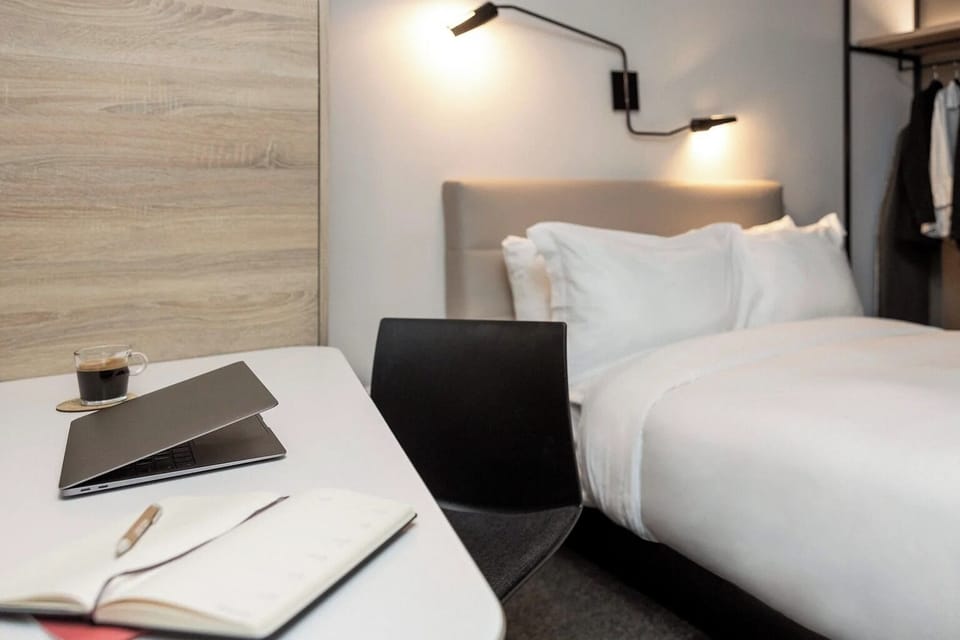Catch up on emails comfortably with a desk beside the bed.