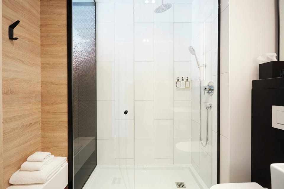 Rinse off in a roomy rainfall shower with sparkling tile.
