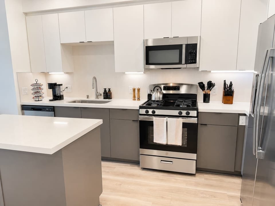 Experience extended comfort with a fully equipped kitchen featuring a coffee machine, stovetop, and microwave—everything you need for a seamless long-term stay.