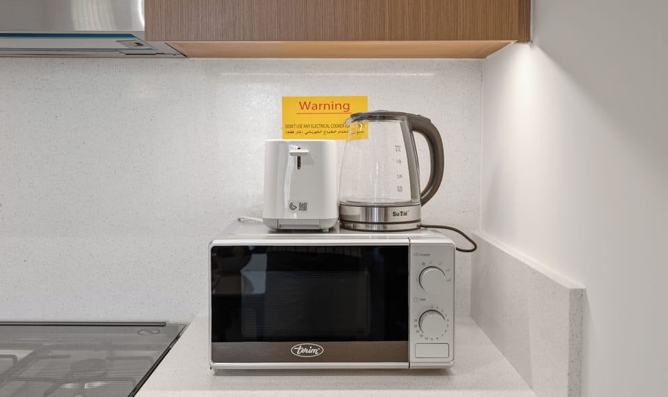 Standard Apartment, City View | Private kitchen | Coffee/tea maker, electric kettle, toaster, highchair