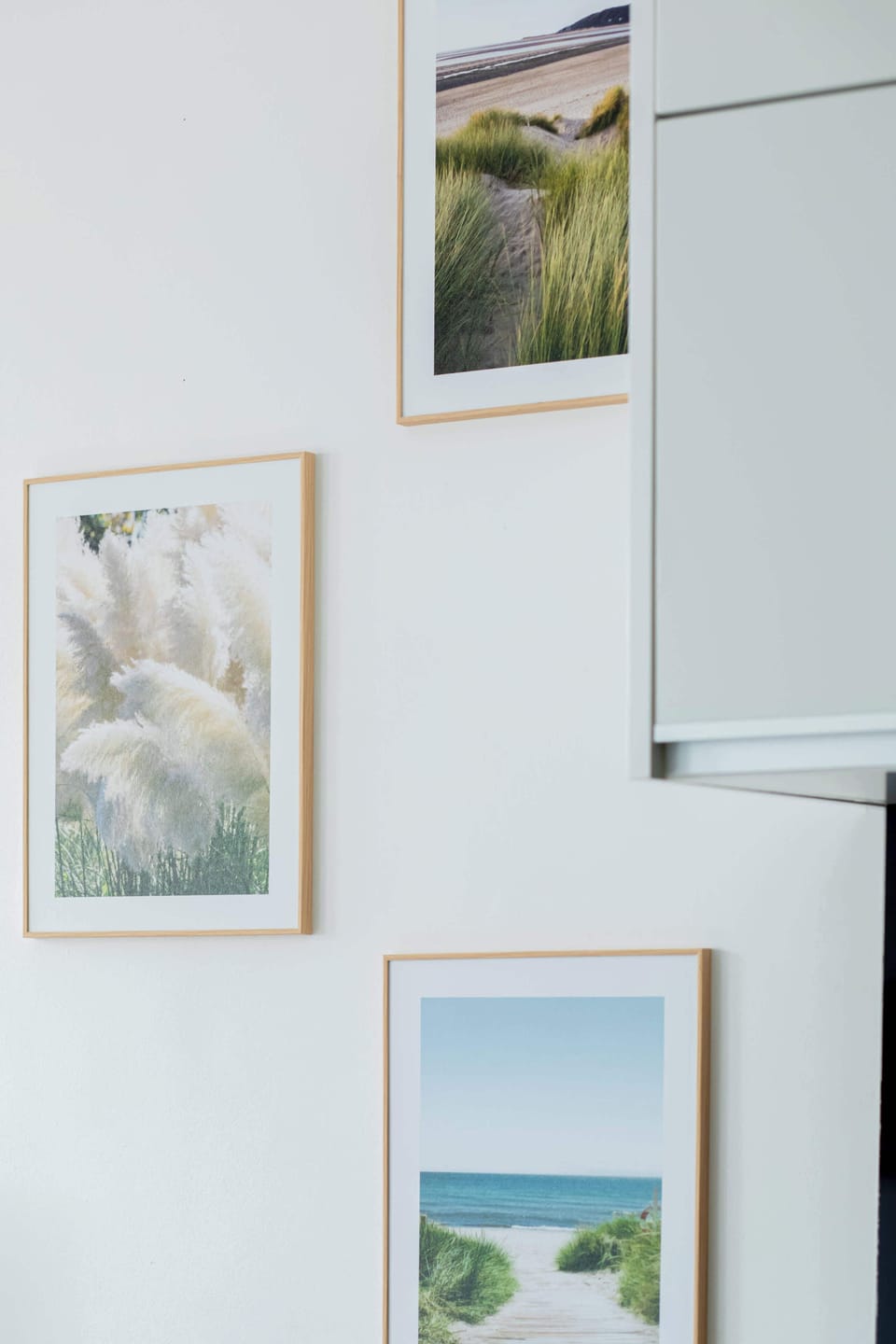 A detail of the apartment’s artistic wall gallery, showcasing calming landscape paintings that add charm and sophistication to the interior.