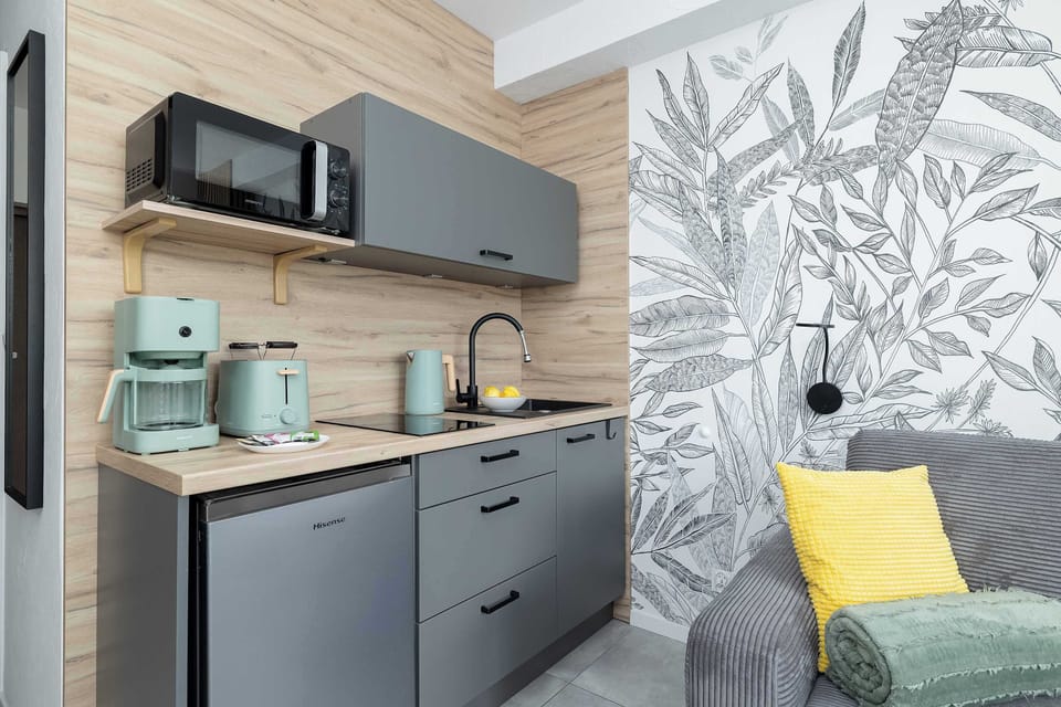 The stylish kitchen with wooden accents and modern appliances makes it easy to prepare homemade meals during your stay.